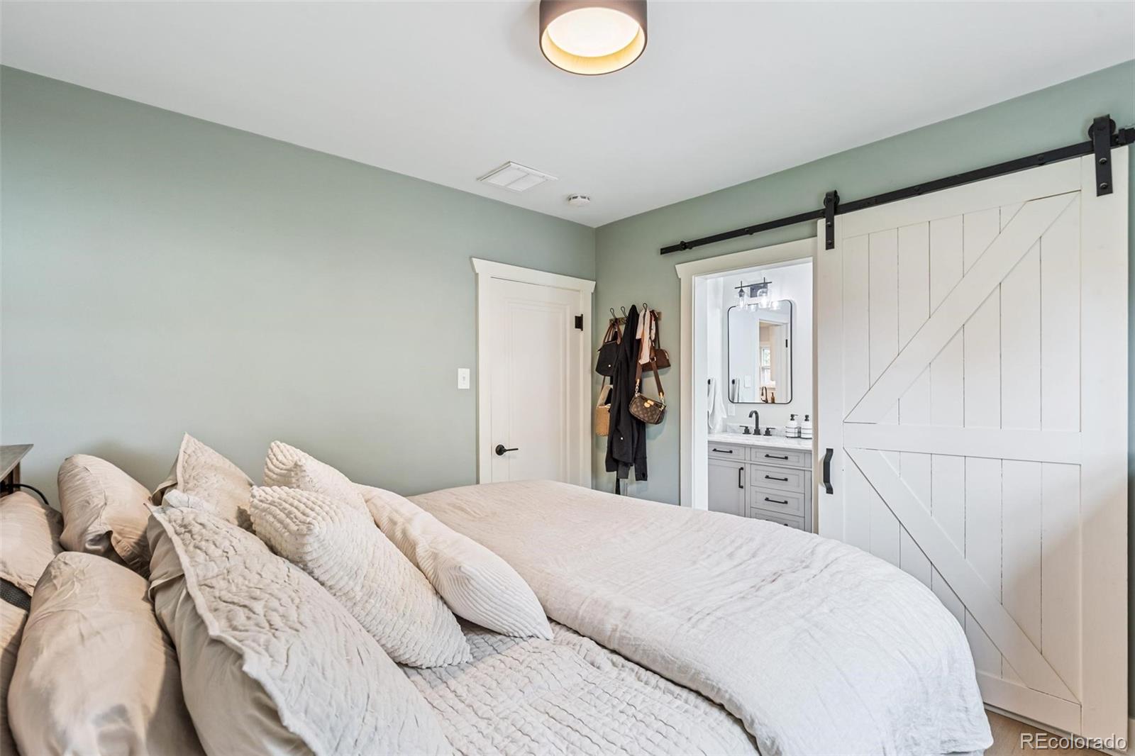 3612 Perry Street Denver, CO 80212 - Photo 19 of 50 a bedroom with a bed and a refrigerator