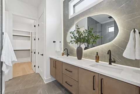 a kitchen with white cabinets and a window