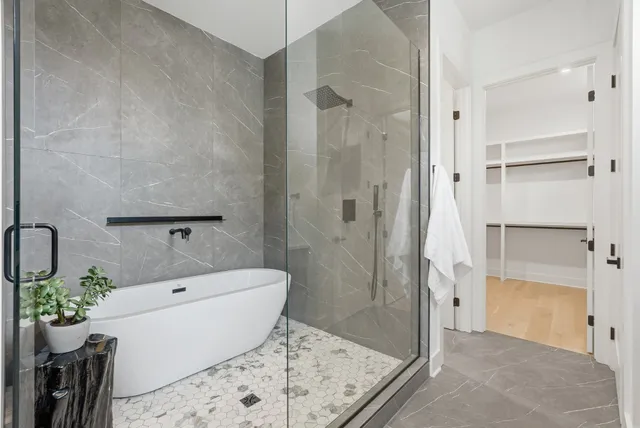 a bathroom with a bathtub and a shower