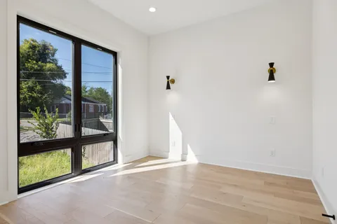 a view of a hallway with wooden floor