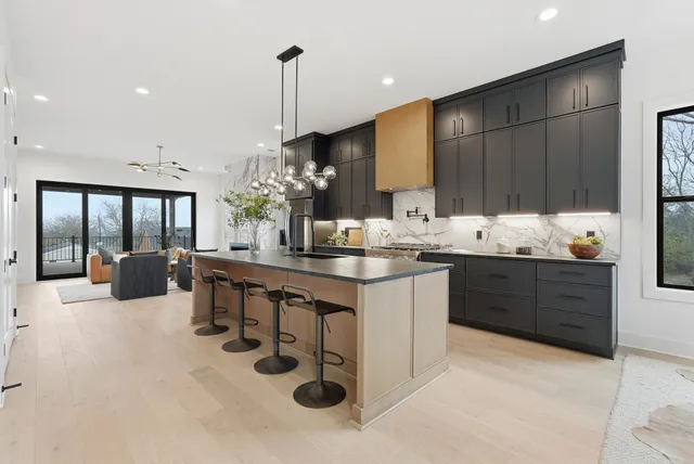 a stove top oven sitting inside of a kitchen