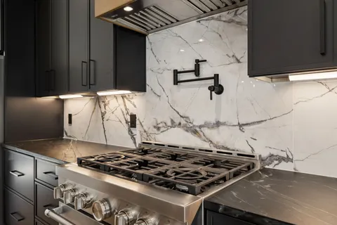 a living room with furniture a fireplace and a large window