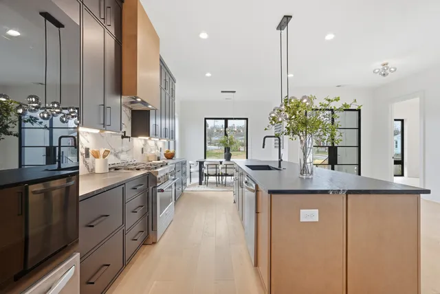 a living room with furniture a fireplace and a large window