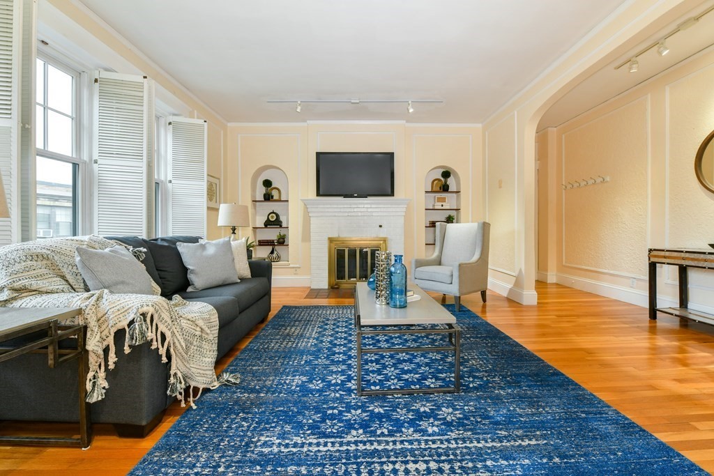 411 Washington Street, Unit 6 Brookline, MA 02446 - Photo 2 of 32 a living room with furniture and a flat screen tv