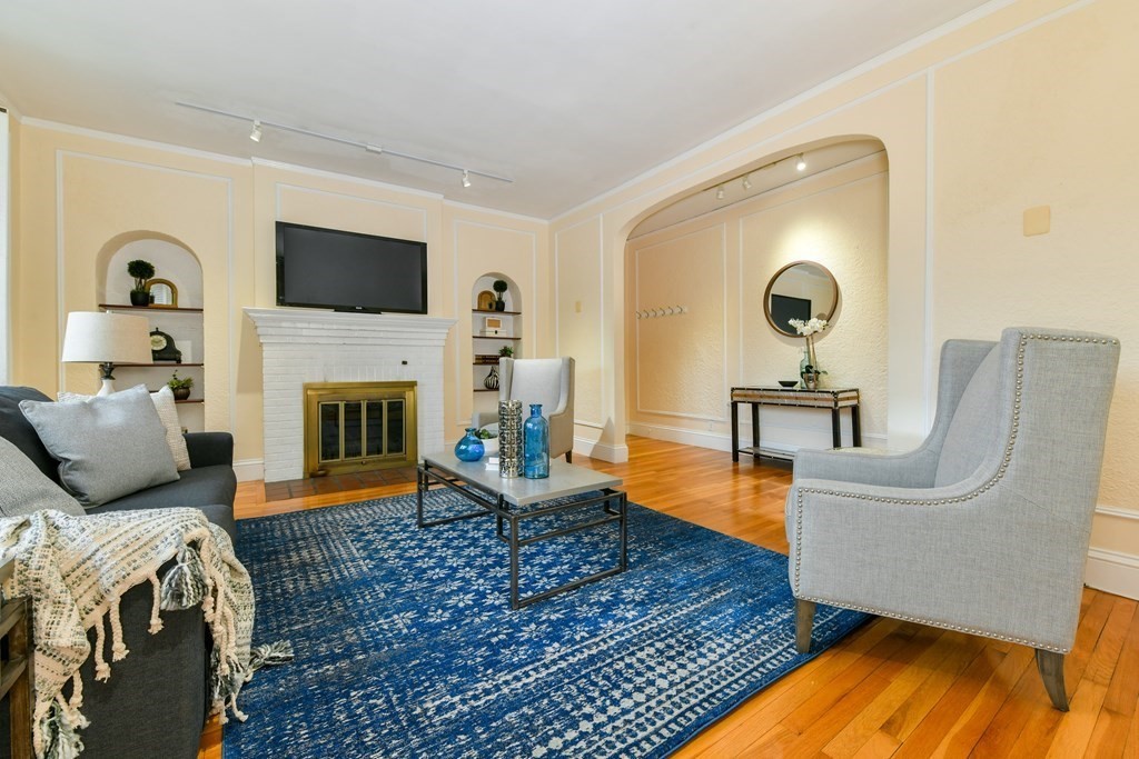 411 Washington Street, Unit 6 Brookline, MA 02446 - Photo 3 of 32 a living room with furniture and a fireplace