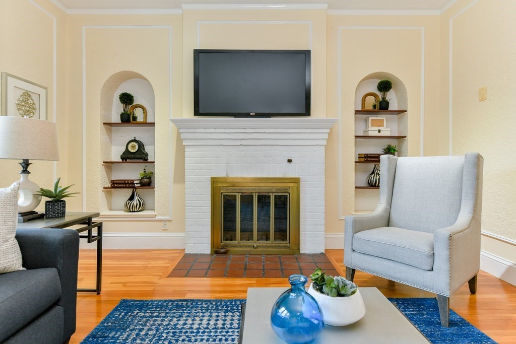 411 Washington Street, Unit 6 Brookline, MA 02446 - Photo 4 of 32 a living room with furniture and a fireplace