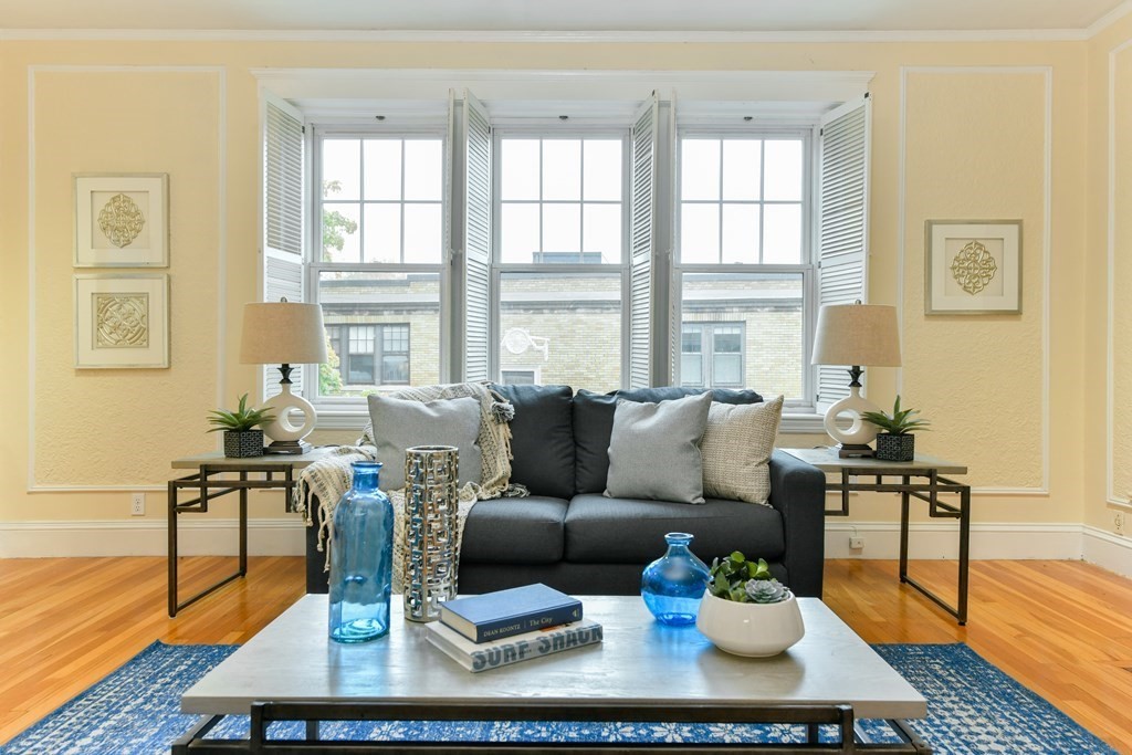 411 Washington Street, Unit 6 Brookline, MA 02446 - Photo 6 of 32 a living room with furniture wooden floor and a table