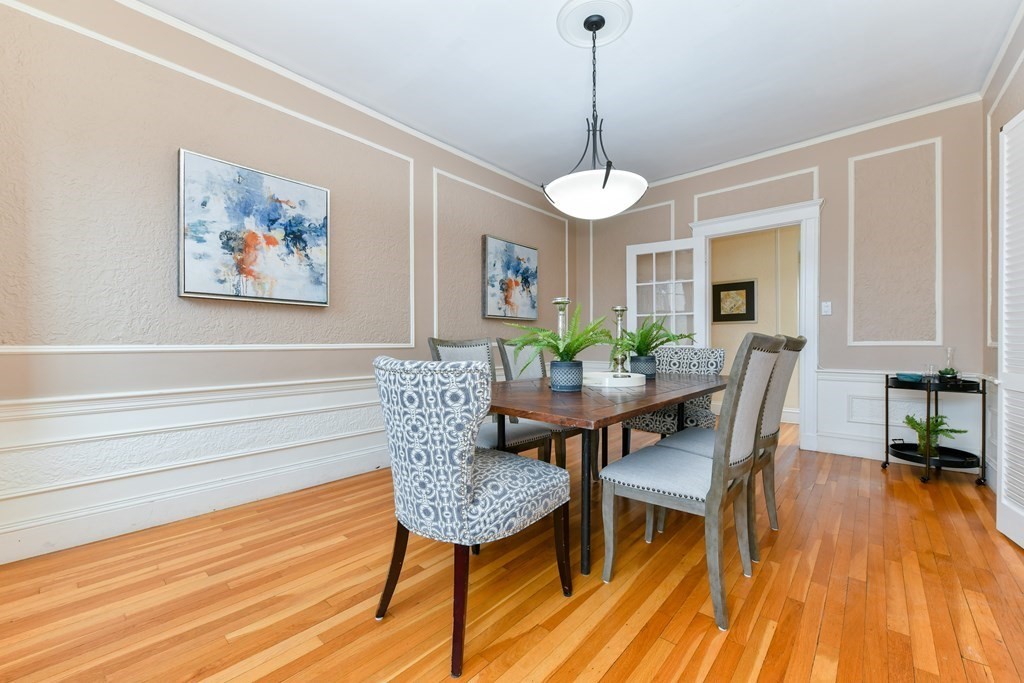 411 Washington Street, Unit 6 Brookline, MA 02446 - Photo 9 of 32 a view of a dining room with furniture wooden floor and chandelier