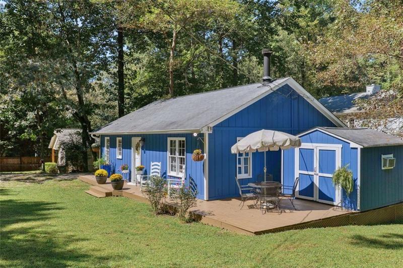 4035 Hawk Street Cumming, GA 30041 - Photo 1 of 1 a patio with a table and chairs under an umbrella