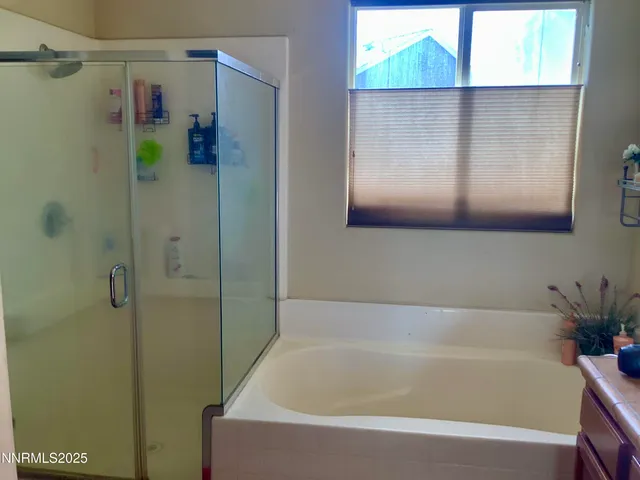 a bathroom with a bathtub and a shower