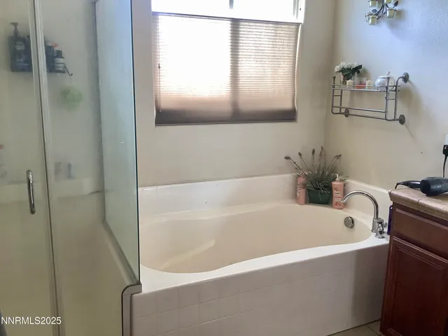 a white bath tub sitting next to a white sink