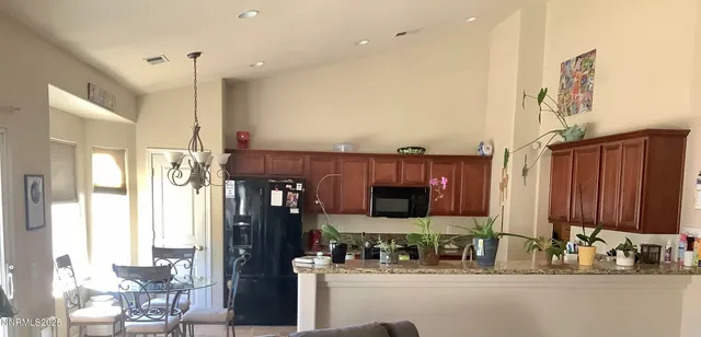 a kitchen with stainless steel appliances a refrigerator and a counter top space