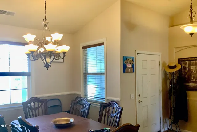 a dining room with furniture and a chandelier
