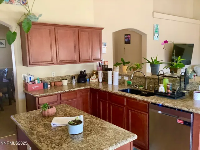 a kitchen with a granite countertop sink and a white cabinets