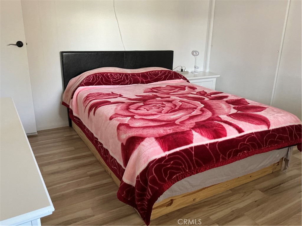 17625 Langlois Road, Unit SPACE 13 Desert Hot Springs, CA 92241 - Photo 11 of 47 a bedroom with a bed and wooden floor