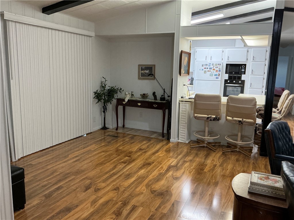17625 Langlois Road, Unit SPACE 13 Desert Hot Springs, CA 92241 - Photo 22 of 47 a kitchen with sink refrigerator and chairs