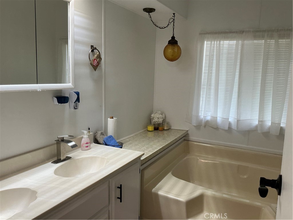 17625 Langlois Road, Unit SPACE 13 Desert Hot Springs, CA 92241 - Photo 6 of 47 a bathroom with a granite countertop sink and a mirror