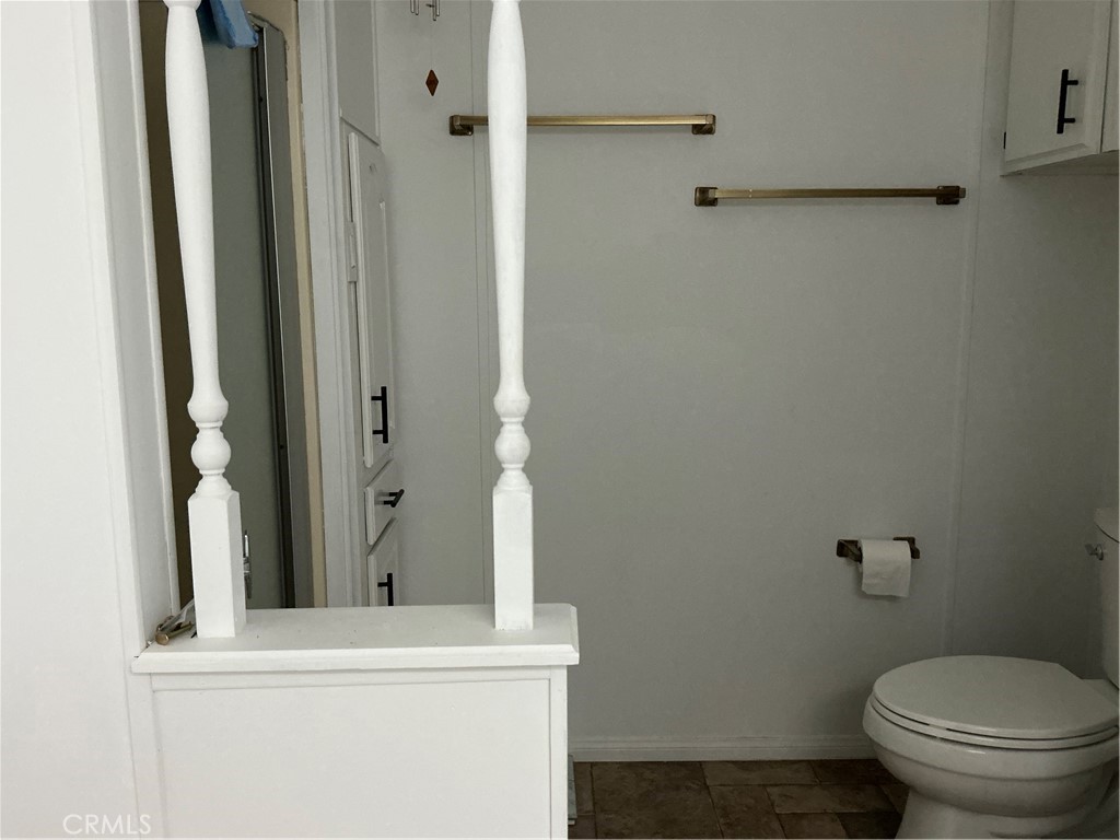 17625 Langlois Road, Unit SPACE 13 Desert Hot Springs, CA 92241 - Photo 7 of 47 a bathroom with a toilet and a mirror