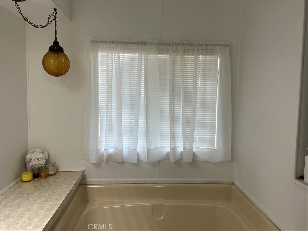 17625 Langlois Road, Unit SPACE 13 Desert Hot Springs, CA 92241 - Photo 9 of 47 a view of a room that has a bed and a chandelier