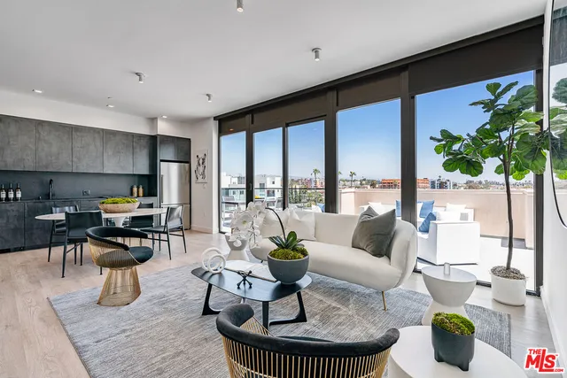 a living room with fireplace furniture and a large window