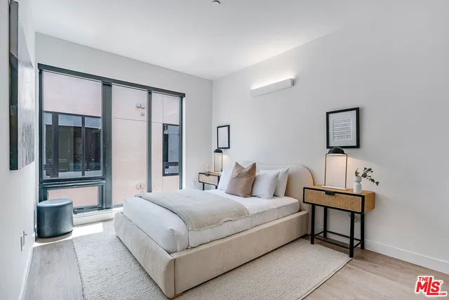 a bedroom with a bed and a night stand