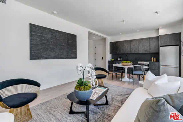 a living room with furniture and kitchen view