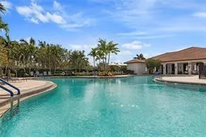 a view of a house with swimming pool and a yard