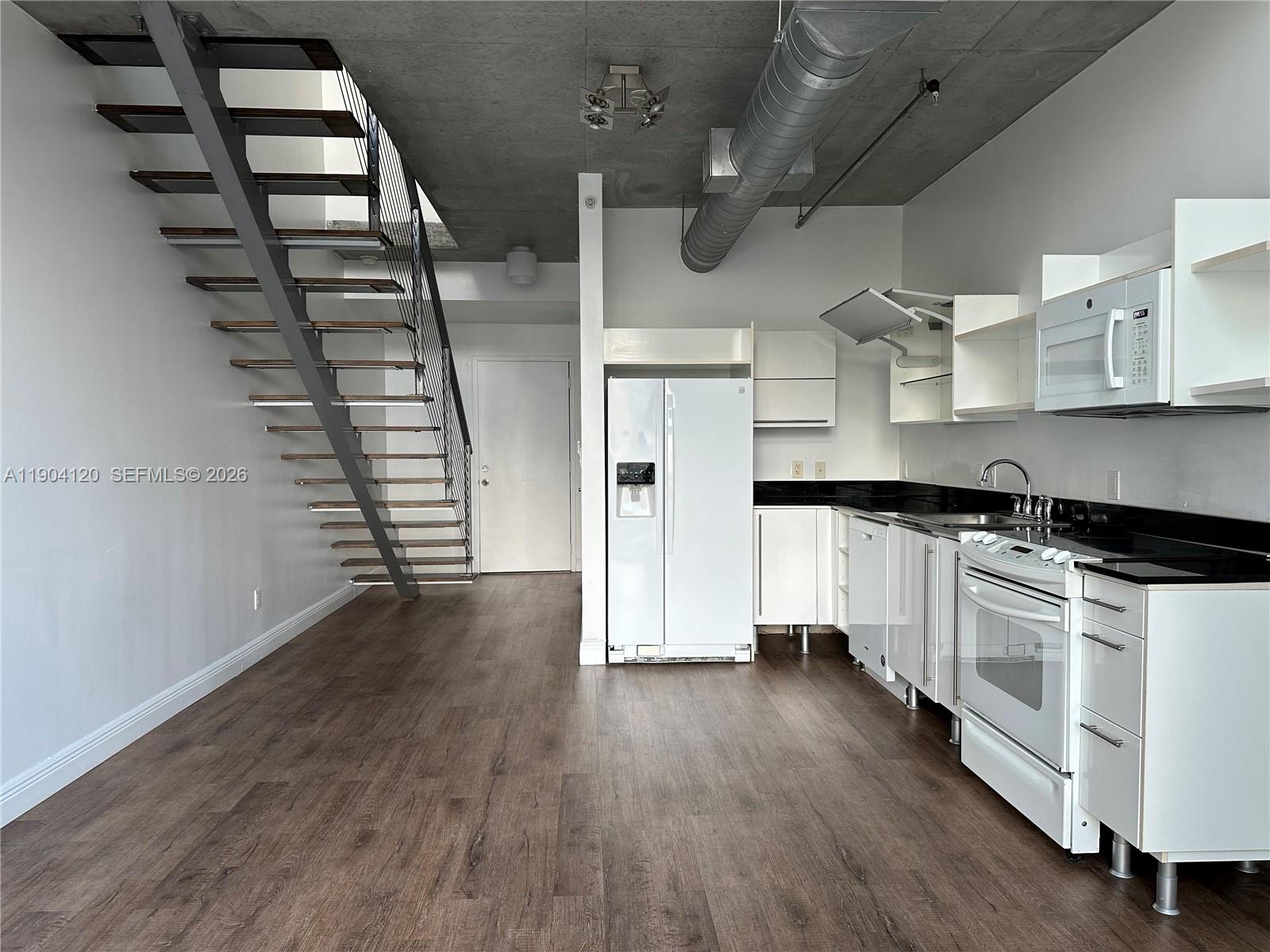690 Southwest 1st Court, Unit 1211 Miami, FL 33130 - Photo 3 of 23 a kitchen with stainless steel appliances a stove and wooden floor