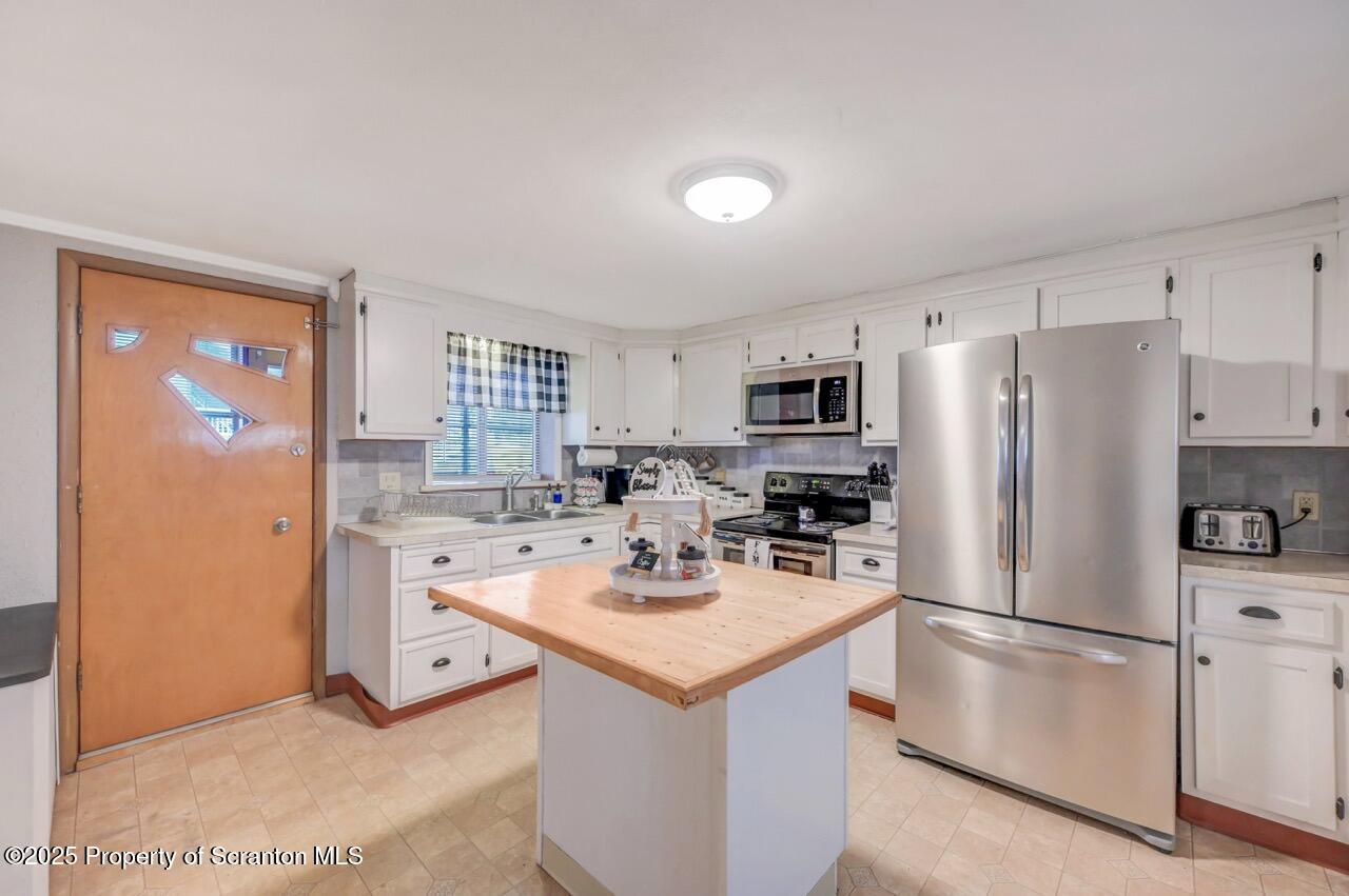 167 Handley Street Eynon, PA 18403 - Photo 15 of 48 a kitchen with stainless steel appliances a refrigerator stove microwave and sink