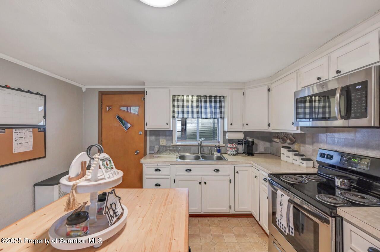 167 Handley Street Eynon, PA 18403 - Photo 18 of 48 a kitchen with a sink stove and window