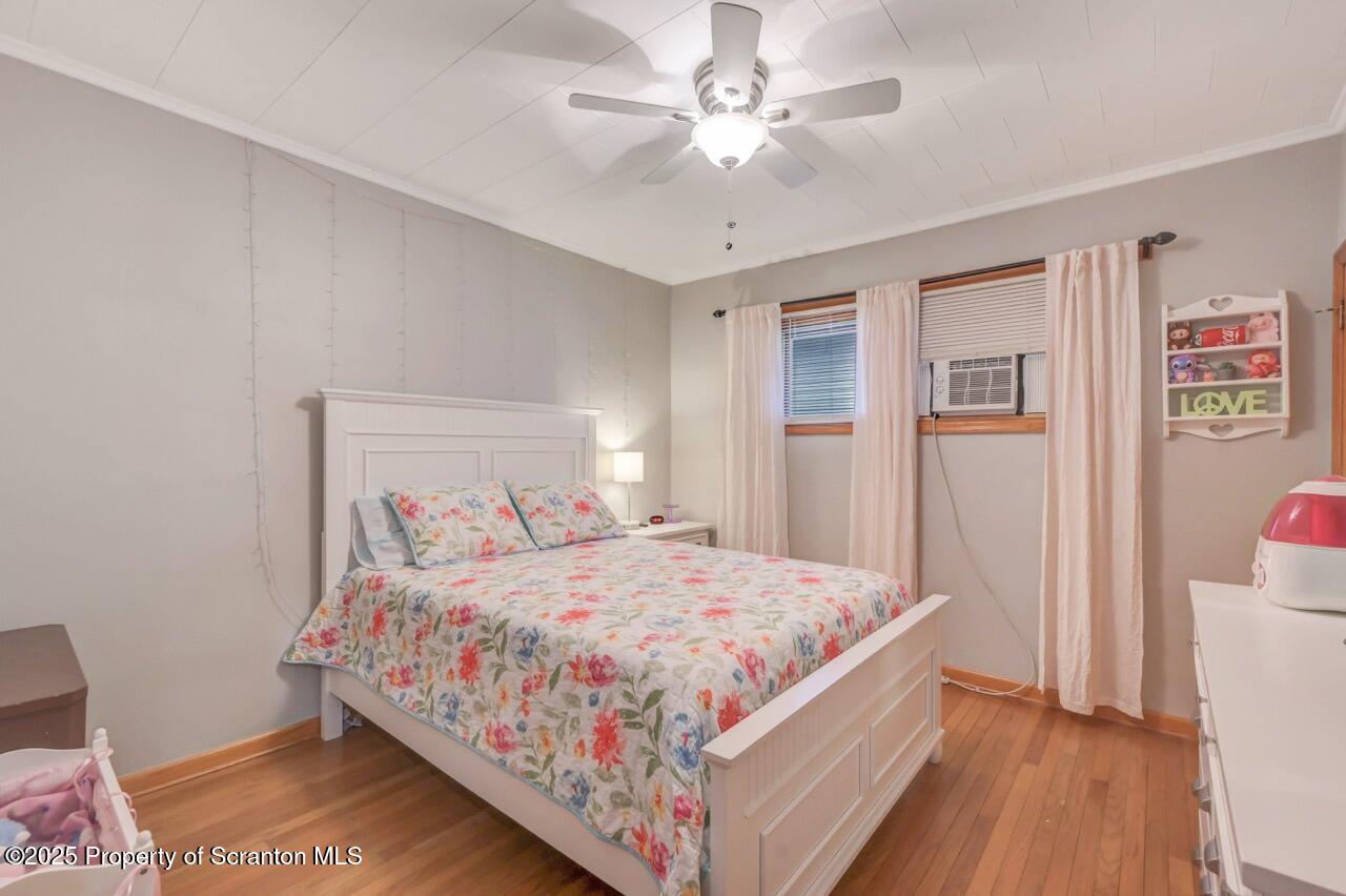 167 Handley Street Eynon, PA 18403 - Photo 24 of 48 a bedroom with a large bed and a chandelier