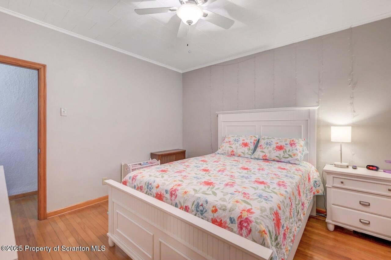 167 Handley Street Eynon, PA 18403 - Photo 25 of 48 a bedroom with a bed and a chandelier