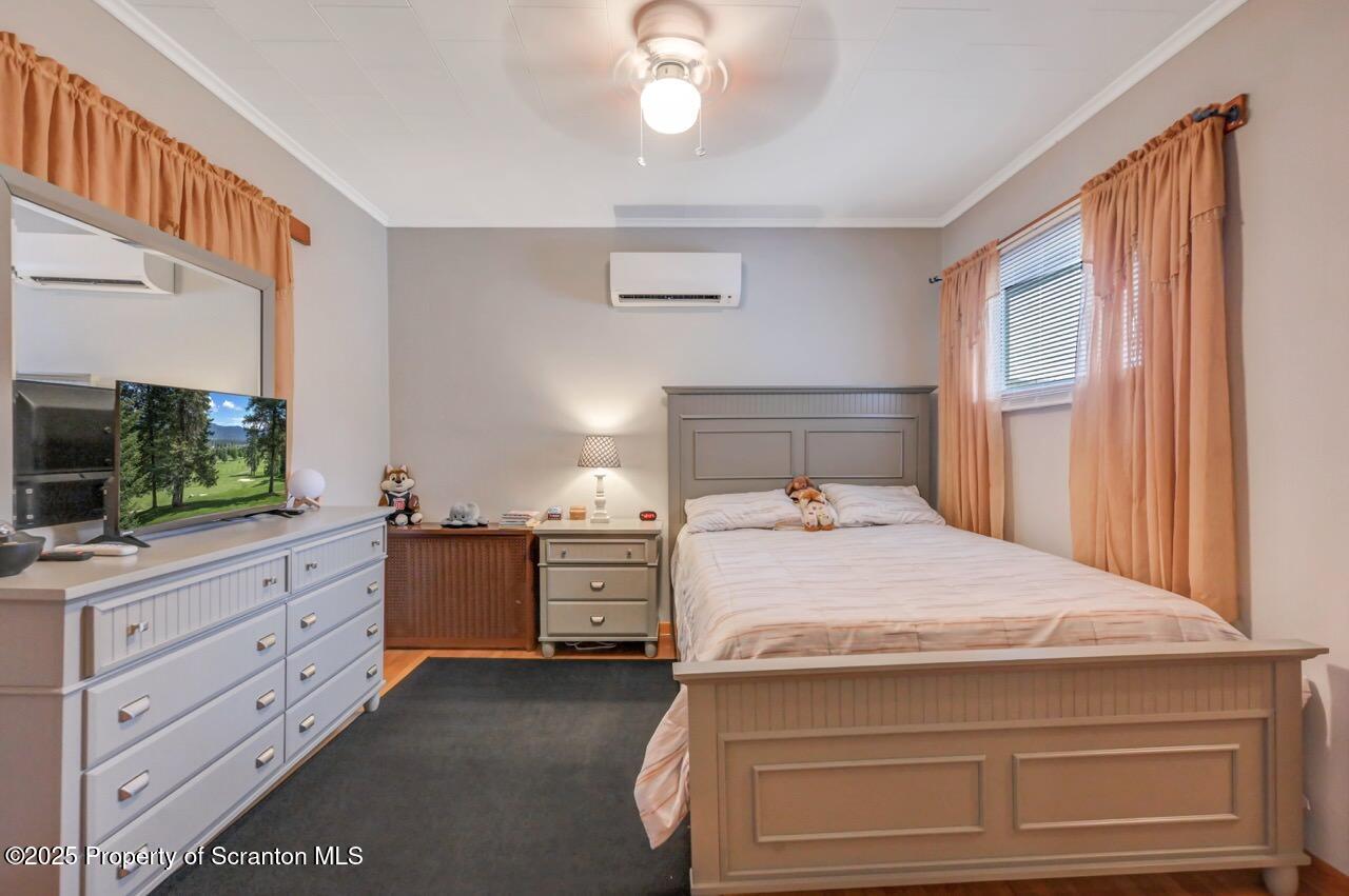 167 Handley Street Eynon, PA 18403 - Photo 28 of 48 a bedroom with a bed and a flat screen tv