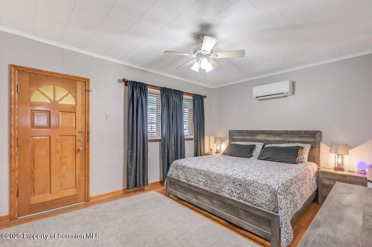 167 Handley Street Eynon, PA 18403 - Photo 30 of 48 a bedroom with a large bed and a chandelier