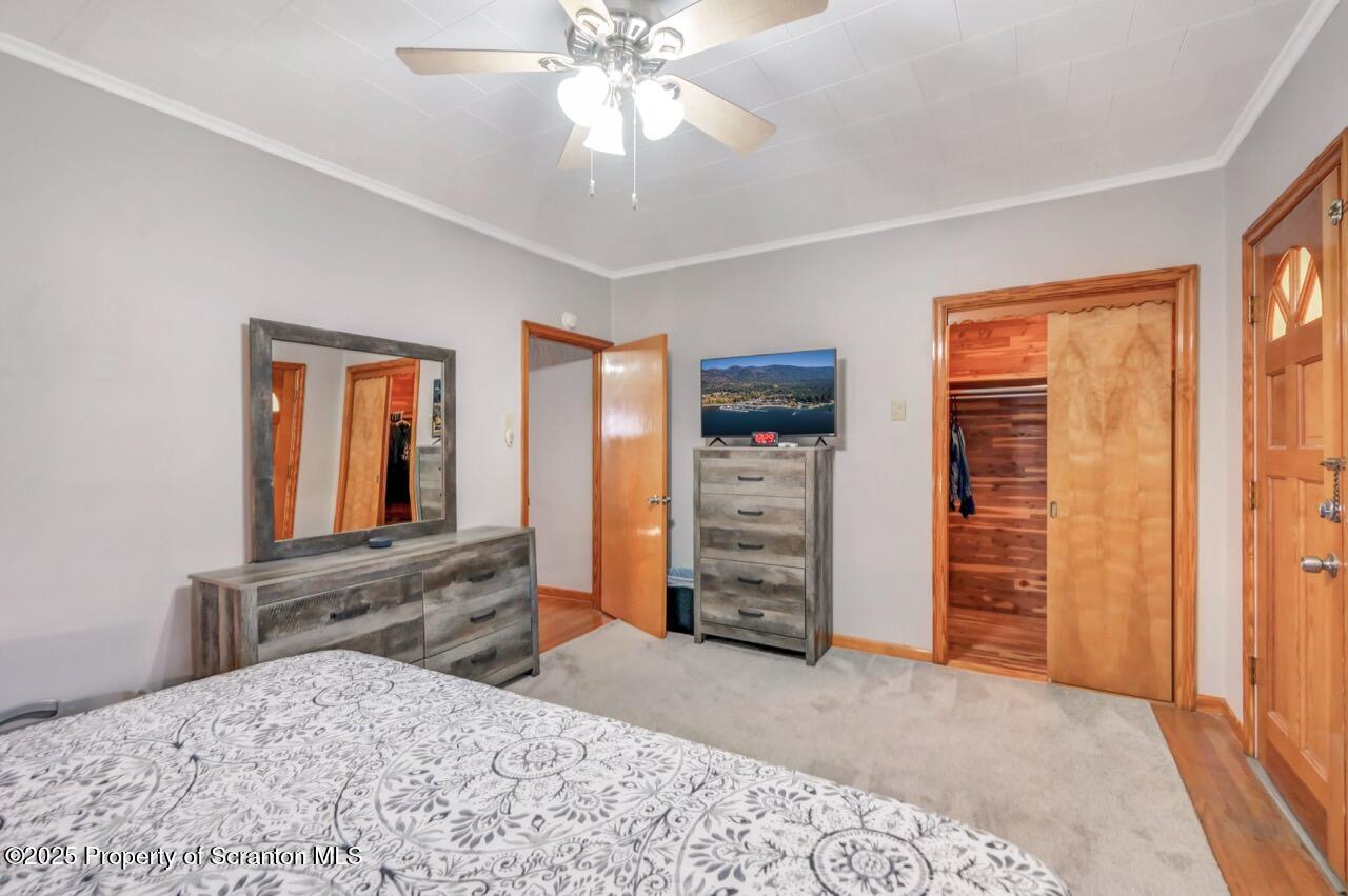 167 Handley Street Eynon, PA 18403 - Photo 33 of 48 a bedroom with a bed and a flat tv screen