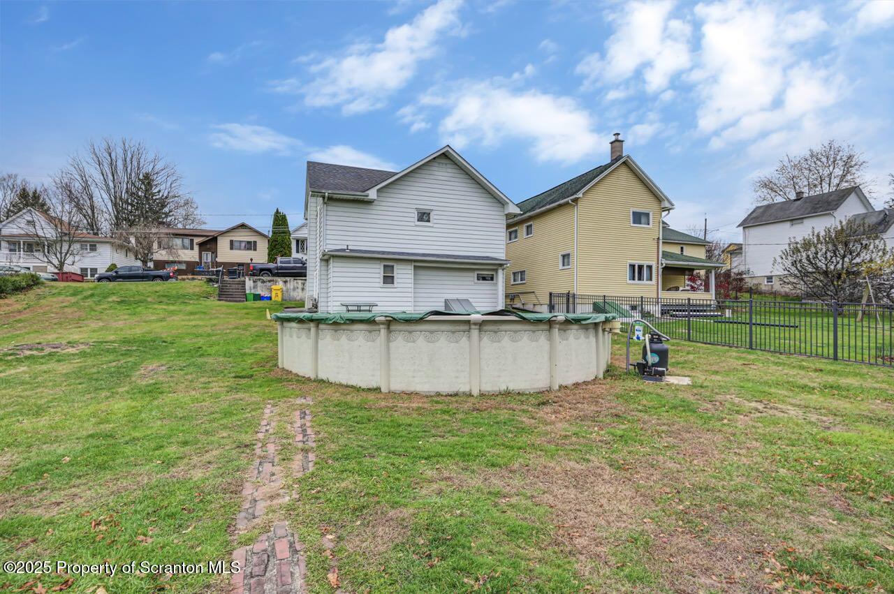 167 Handley Street Eynon, PA 18403 - Photo 43 of 48 a view of a house with a yard and a large tree