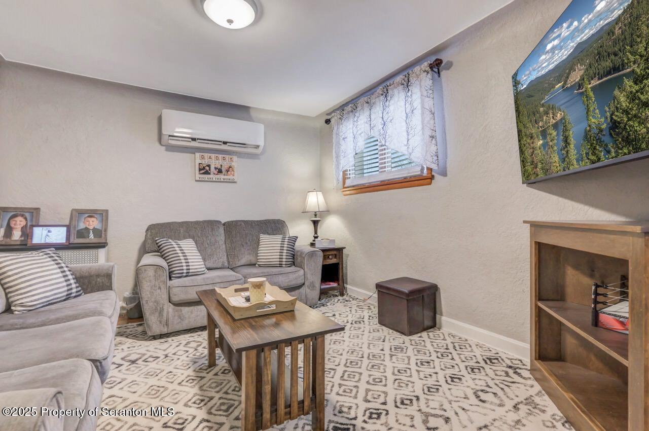 167 Handley Street Eynon, PA 18403 - Photo 6 of 48 a living room with furniture a rug and a window