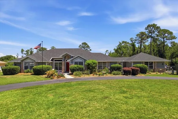 a front view of a house with garden