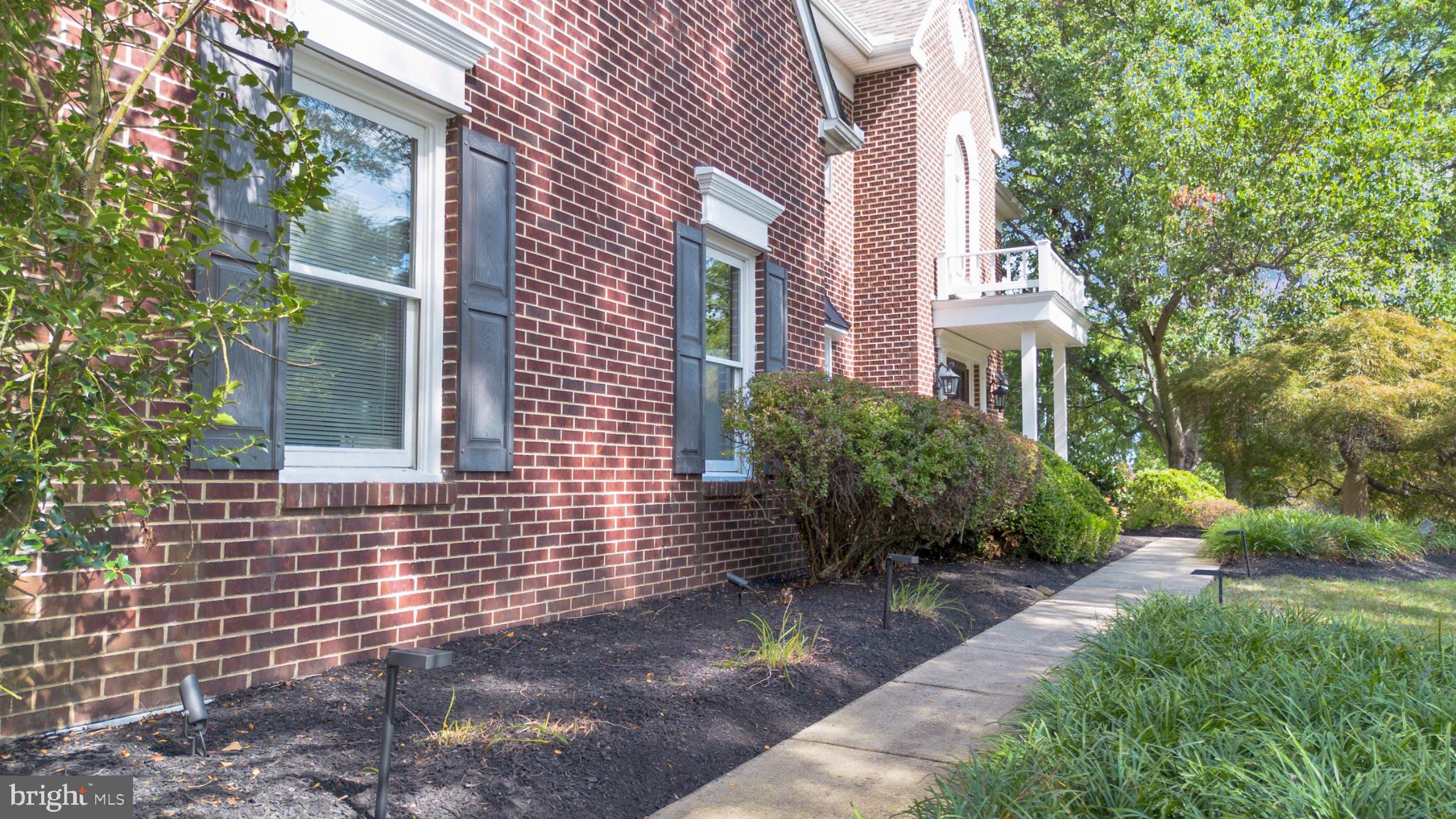112 South Mennonite Road Collegeville, PA 19426 - Photo 13 of 131 Charming brick facade with lush greenery.