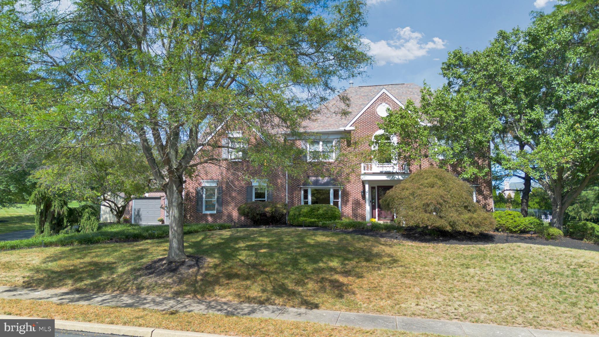 112 South Mennonite Road Collegeville, PA 19426 - Photo 2 of 131 Charming brick home with lush greenery.
