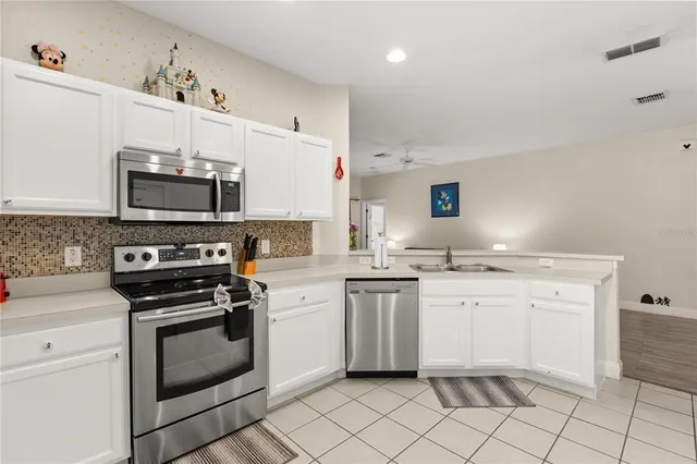 a kitchen with cabinets and washer dryer