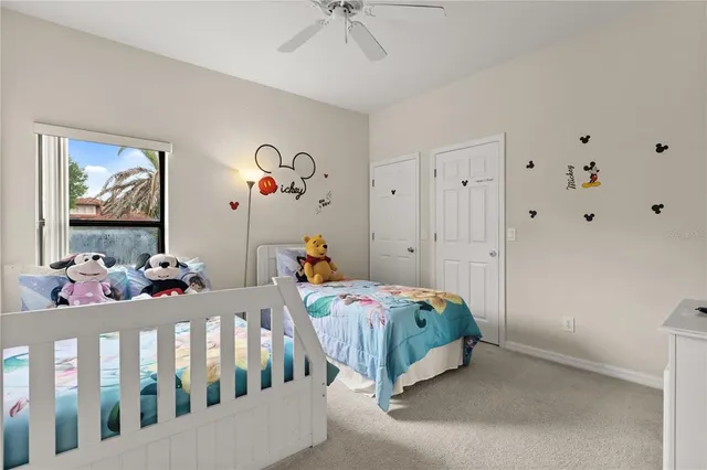 a bedroom with bed and wooden floor