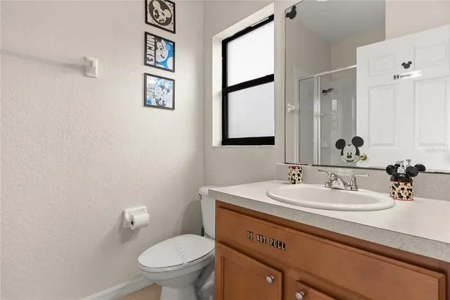 a bedroom with a bed and large window