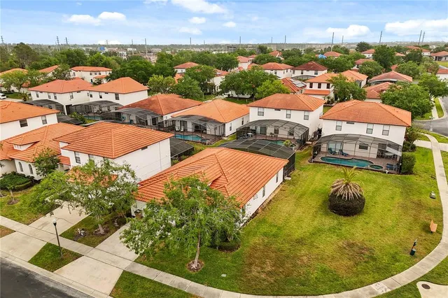 an aerial view of residential houses with outdoor space and river