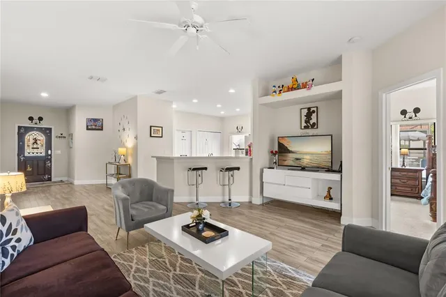 a living room with furniture and kitchen view