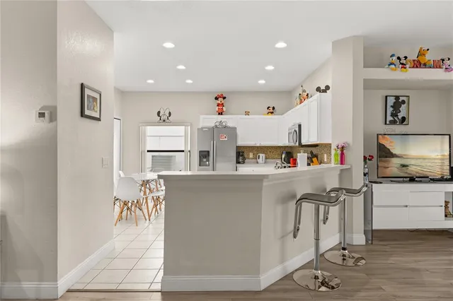 a kitchen with stainless steel appliances a refrigerator and a stove top oven