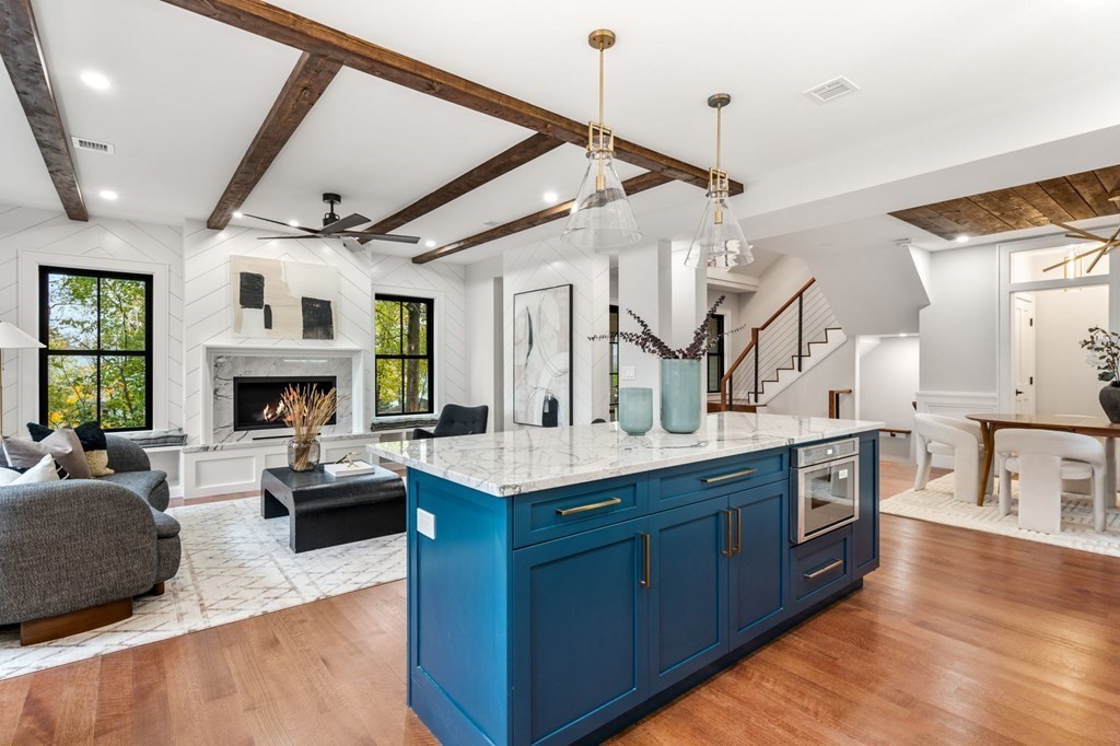 300 Elliot Street, Unit 2 Newton, MA 02464 - Photo 1 of 16 a large living room with stainless steel appliances granite countertop a stove and a wooden floors