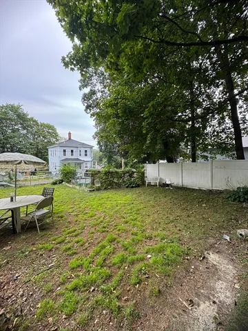 a view of a backyard with swimming pool