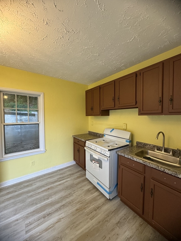 20 Temple Street, Unit 1 Fitchburg, MA 01420 - Photo 5 of 14 a kitchen with a stove and a sink