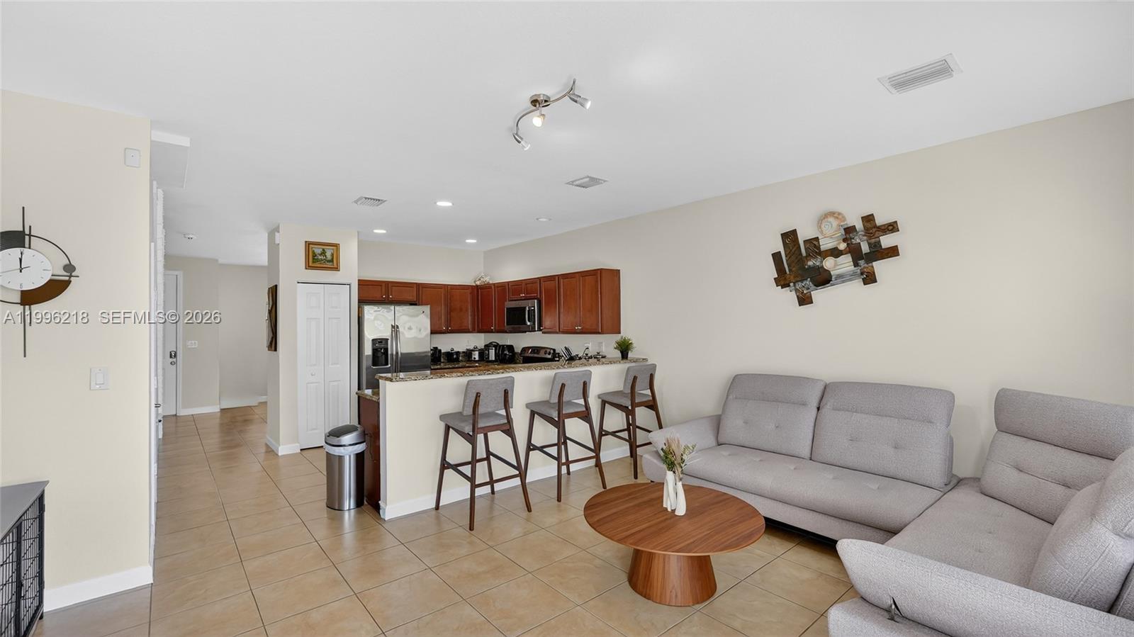 9041 Southwest 227th Street, Unit 5 Cutler Bay, FL 33190 - Photo 1 of 41 a living room with furniture and a flat screen tv